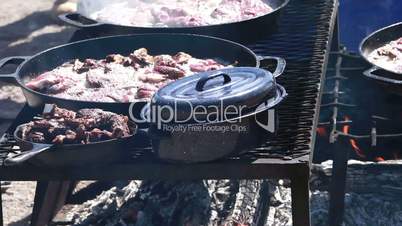 Lamb steaks cooking over open fire P HD 8907