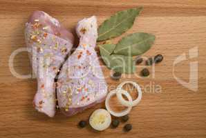 raw chicken meat with herbs, onions and peppers