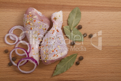 raw chicken meat with herbs, onions and peppers