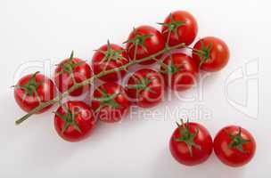 ripe cherry tomatoes on a branch