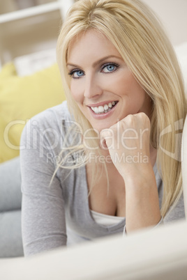 Happy Blond Woman With Blue Eyes Resting on her Hand