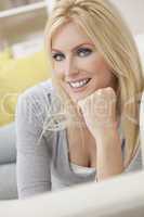 Happy Blond Woman With Blue Eyes Resting on her Hand