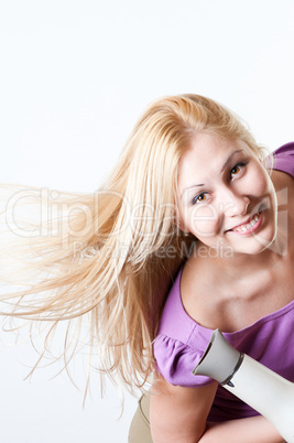 Portrait of a girl with a hairdryer