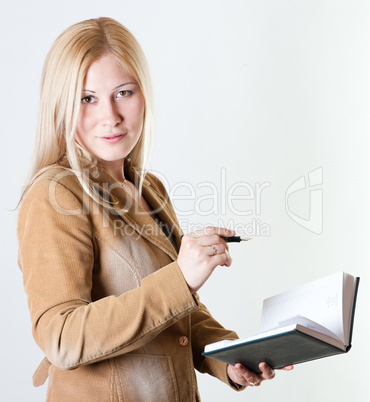 Businesswoman with a notepad and an ink pen
