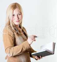 Businesswoman with a notepad and an ink pen