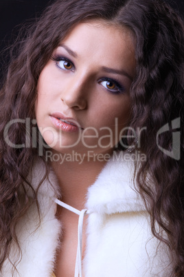 Young pretty girl close-up portrait in fur coat