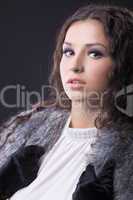 Young sensual girl close-up portrait in fur coat