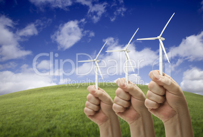 Male Fists Holding Three Wind Turbines Outside