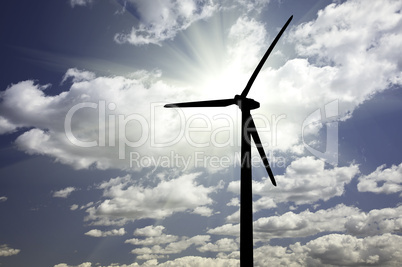 Silhouetted Wind Turbine Over Dramatic Sky