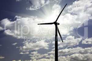 Silhouetted Wind Turbine Over Dramatic Sky