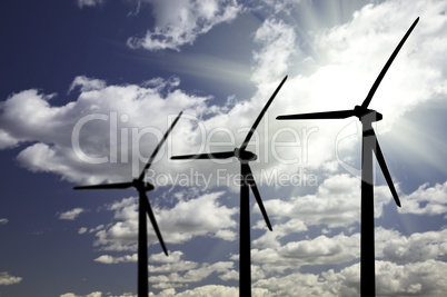Silhouetted Wind Turbines Over Dramatic Sky