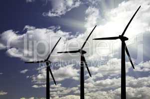 Silhouetted Wind Turbines Over Dramatic Sky