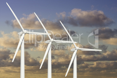Three Wind Turbines Over Dramatic Blue Sky