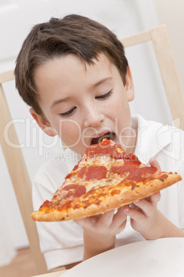 Young Boy Child Eating Slice of Pizza