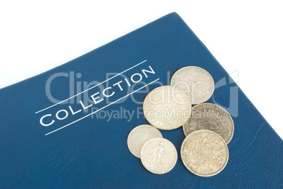 old silver coins on an album