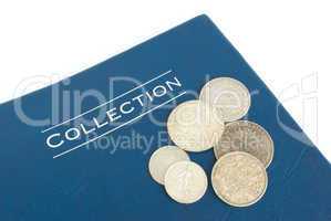 old silver coins on an album