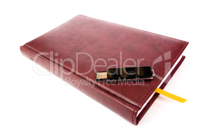 USB flash drive on leather notebook