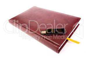 USB flash drive on leather notebook