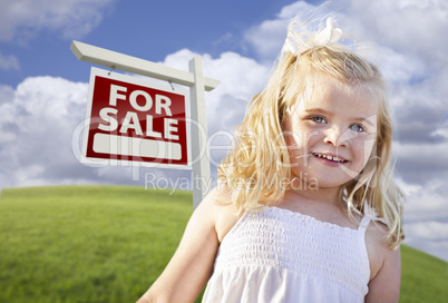 Smiling Cute Girl in Field with For Sale Real Estate Sign