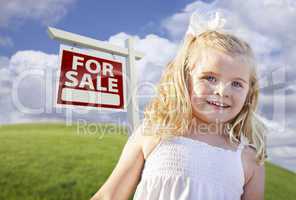 Smiling Cute Girl in Field with For Sale Real Estate Sign