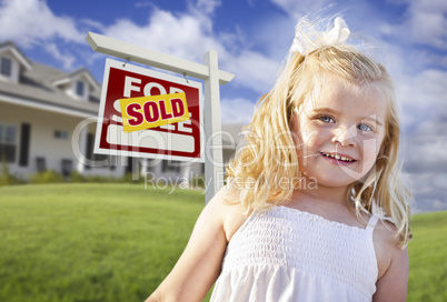 Cute Girl in Yard with Sold For Sale Real Estate Sign and House