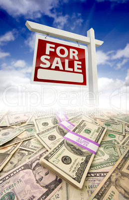 Stacks of Money and For Sale Real Estate Sign