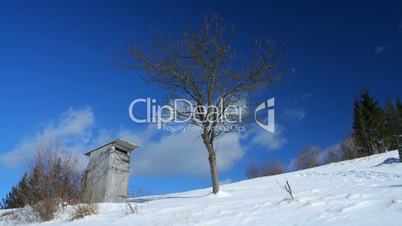 Time-lapse of white clouds passing by over winter landscape in Carpathian Mountains