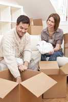 Happy Couple Unpacking or Packing Boxes Moving House