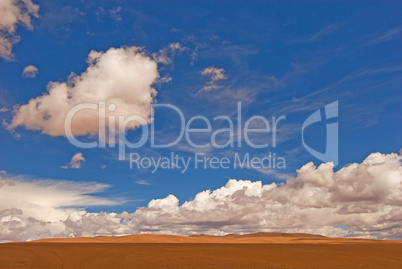 desert landscape white clouds and deep blue sky
