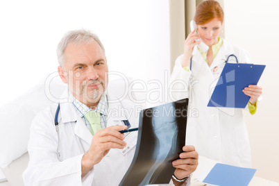 Medical team - senior doctor x-ray in hospital