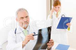 Medical team - senior doctor x-ray in hospital