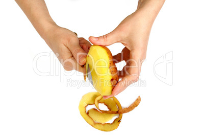Beautiful women's hands clean potatoes peeled