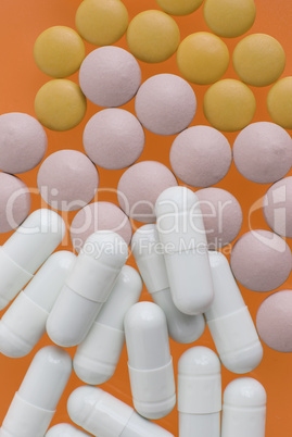 White, pink and orange pills