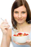 Healthy lifestyle - woman eat strawberry cereal
