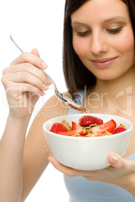 Healthy lifestyle - woman eat strawberry cereal