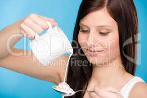 Healthy lifestyle - young woman pour milk cereal