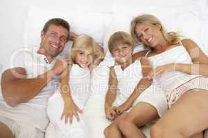 Familie liegt im Bett