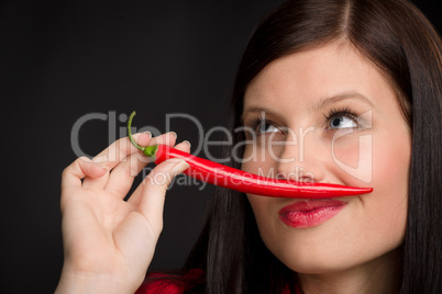 Chili pepper - portrait young woman red spicy