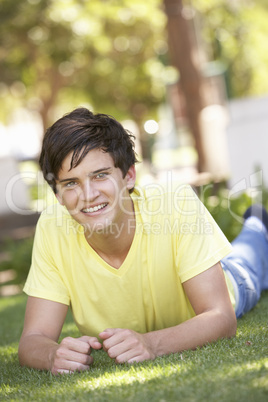 Portrait Of Teenage Boy Laying In Park