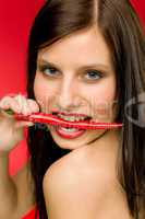 Chili pepper - portrait young woman bite red spicy