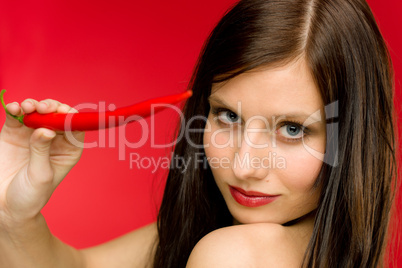 Chili pepper - portrait young woman red spicy