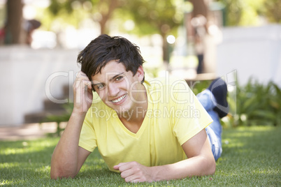 Portrait Of Teenage Boy Laying In Park