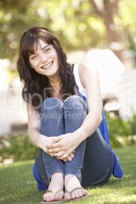 Portrait Of Teenage Girl Sitting In Park Portrait Of Teenage Girl Sitting In Park