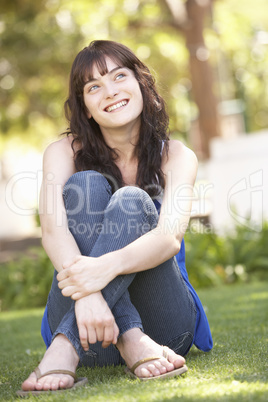 Portrait Of  Teenage Girl Sitting In Park