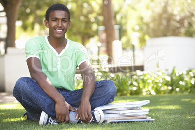 Male Teenage Student Studying In Park