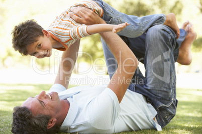 Father And Son Playing Together In Park