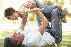 Father And Son Playing Together In Park