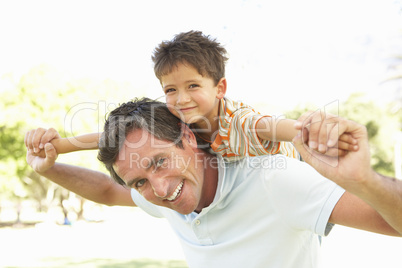 Father Giving Son Ride On Back
