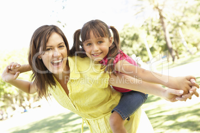 Mother Giving Daughter Ride On Back