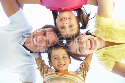 Family Group Looking Down Into Camera